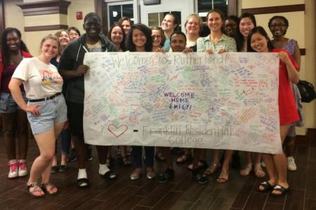 Students holding welcome sign in Rutherford