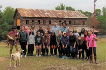FRC members take group picture in front of Sweet Olive Farm