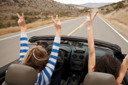 People in car driving down road